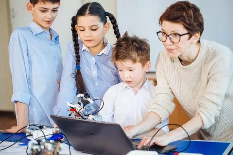 Happy children learn programming using laptops on extracurricular classes 스톡 사진