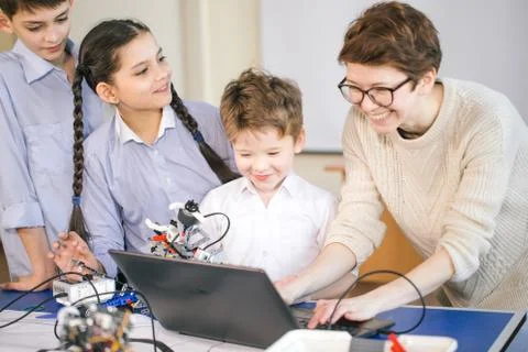 Happy children learn programming using laptops on extracurricular classes 스톡 사진