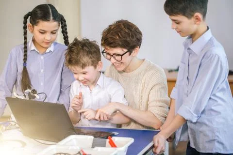 Happy children learn programming using laptops on extracurricular classes 스톡 사진