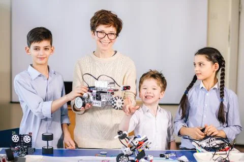 Happy children learn programming using laptops on extracurricular classes 스톡 사진