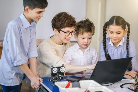 Happy children learn programming using laptops on extracurricular classes 写真素材