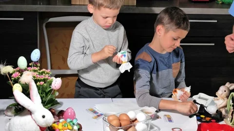 Happy children painting Easter eggs Stock Footage 163980720