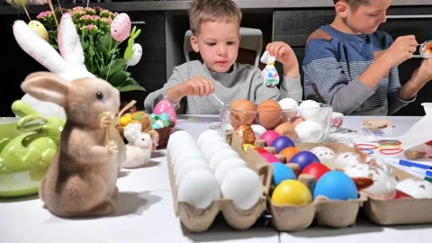 Happy children painting Easter eggs Stock Footage 163980989
