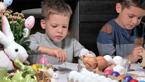 Happy children painting Easter eggs Stock Footage 163983111