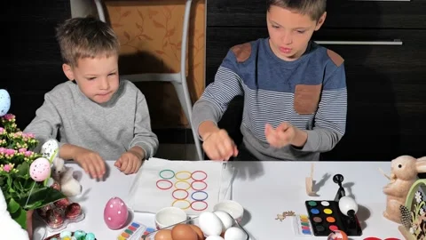 Happy children painting Easter eggs Stock Footage 163983383