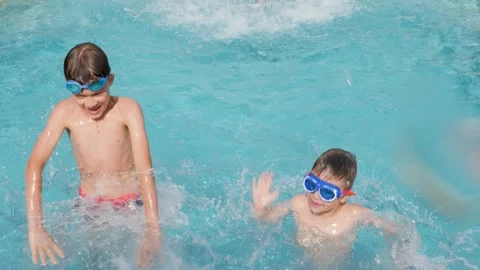 Happy children pool fun splash water happy summer kids splashing in pool kids Stock Footage 241398787