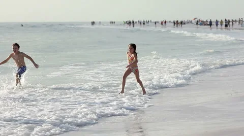 Happy children running on the beach Stock Footage 1003224