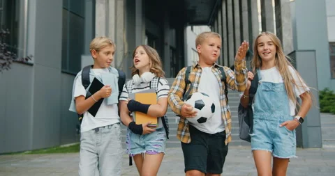 Happy children talking smiling walking outside. Group of cheerful energetic Stock Footage 248616642