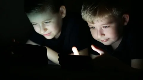  Happy children using smart phone together browsing online.   Boy and girl at ho Stock Footage 80604869