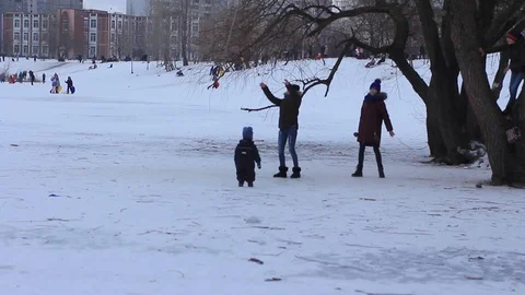 Happy Children's Bungee winter games lake snowing on the frozen lake Stock Footage 101581906