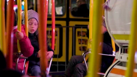 Happy Childrens Have Fun sitting on Carousel by Night Stock Footage 121209953