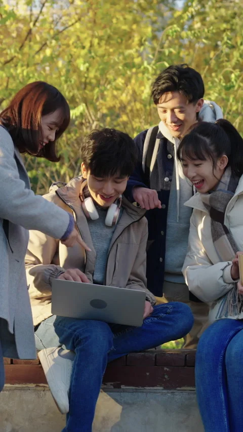 Happy Chinese college students using laptop and discussing,HD Stock Footage 238055462