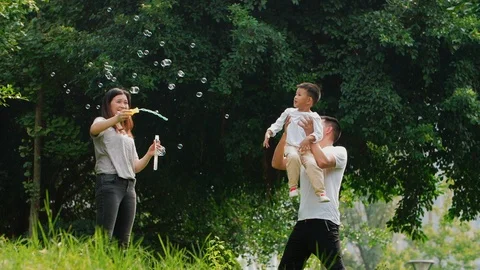 Happy Chinese family playing outdoor in the park Stock Footage