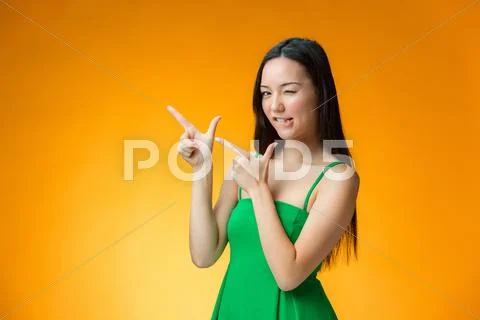 The happy Chinese girl on yellow background Stock Photos