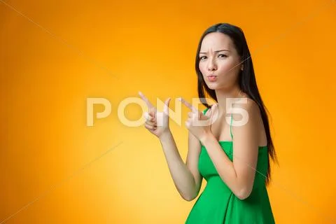 The happy Chinese girl on yellow background Stock Photos