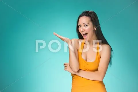 The happy Chinese girl on yellow background Stock Photos