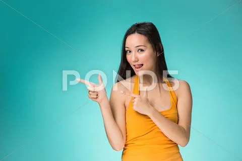 The happy Chinese girl on yellow background Stock Photos