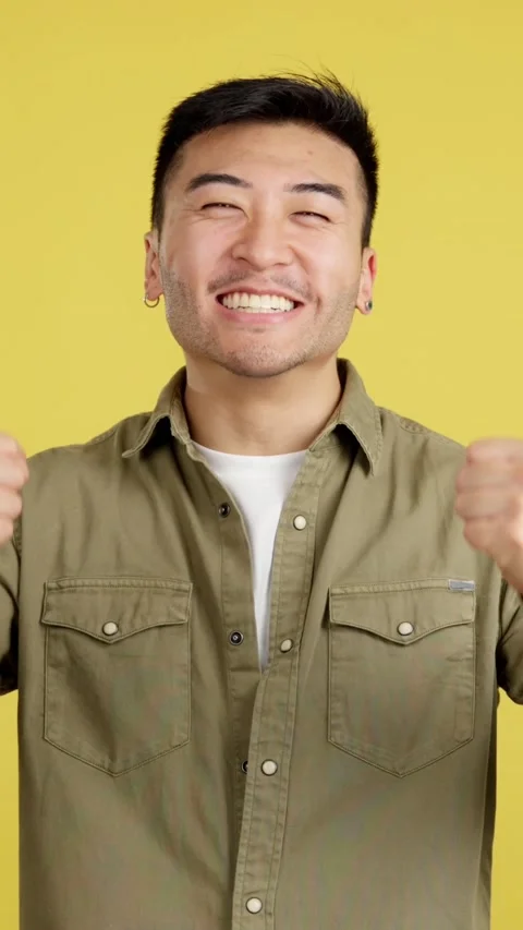 Happy chinese man celebrating while raising fists Stock Footage 239266578