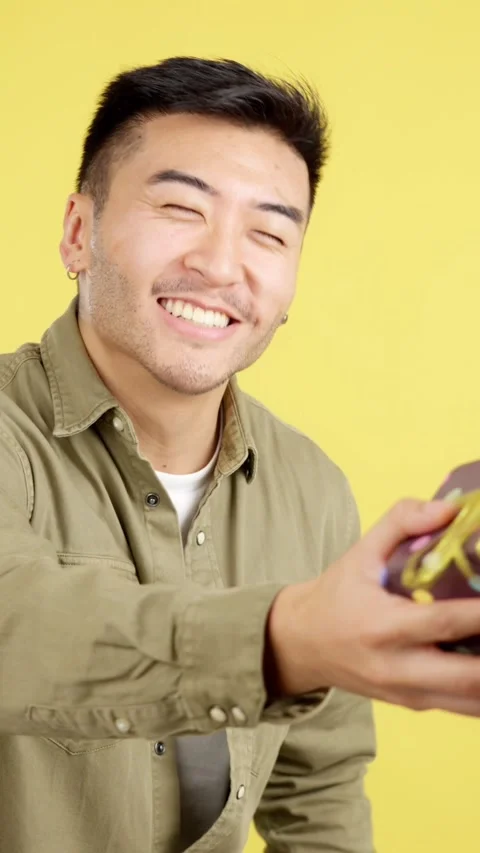 Happy chinese man smiling while receiving a gift Stock Footage 245620778
