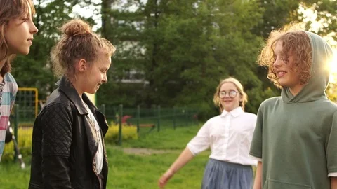 Happy classmates hug while walking in the park, school friendship, back to Stock Footage 112150210