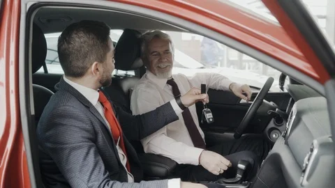 Happy client is getting the key of his new car. Sitting in the car. Stock Footage 91187002
