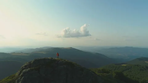 Happy climber reaching the top of the mountain successfully Stock Footage 157905654