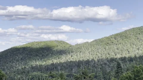 Happy clouds over green hillsides and valley  Stock Footage 284875883