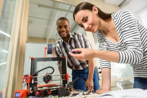 Happy colleagues using 3d printer Stock Photos