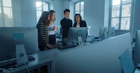 Happy communication. Young startup team in office, laughing discussing a project Stock Footage 127005476