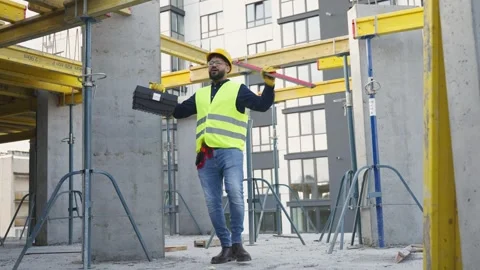 Happy construction worker dancing at building site Stock Footage 343449929
