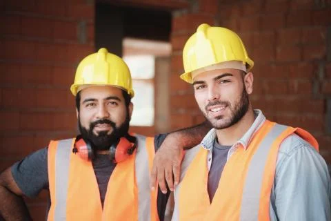 Happy Construction Workers Smiling At Camera In New Building Stock Photos