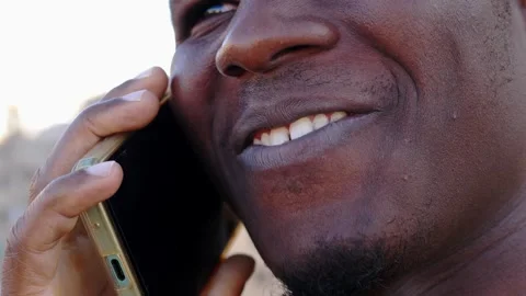 Happy Conversation: Close-up of Smiling Young Black Man on Phone Stock Footage 262310037