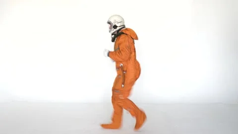 Happy cosmonaut having fun while dancing on a white background Stock Footage 258351310