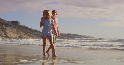 Happy, couple and beach with fun, swing and tropical island with love, care and Stock Footage 307701564