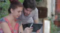 happy couple are having fun looking at photos with your tablet HD Footage