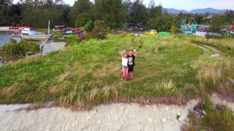Happy couple on the beach, the drone camera is removed to the top Stock Footage 79556221