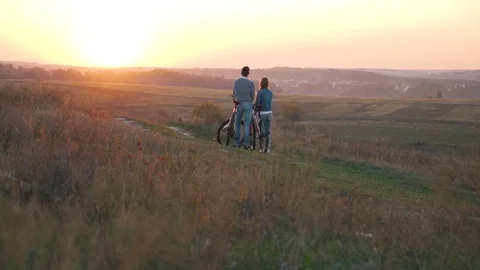 A happy couple with bikes at sunset Stock-Footage 80838737