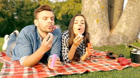 Happy couple is blowing bubbles. Stock Footage 101692648