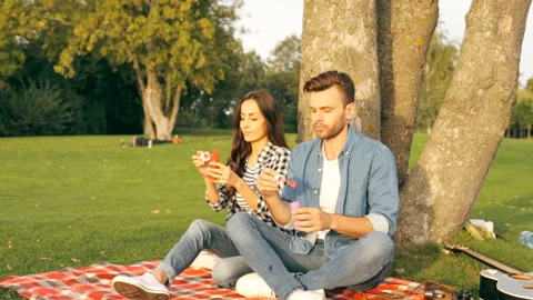 Happy couple is blowing bubbles. Stock Footage 101692669