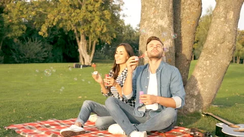 Happy couple is blowing bubbles. Stock Footage 101692751