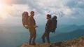 The happy couple with camping backpacks standing in the mountain. slow motion 4k or 4k+ Resolution