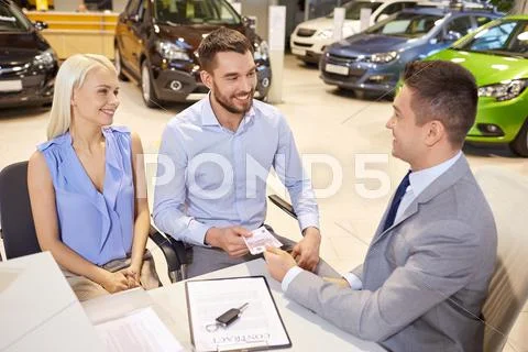 Happy Couple With Car Dealer In Auto Show Or Salon
