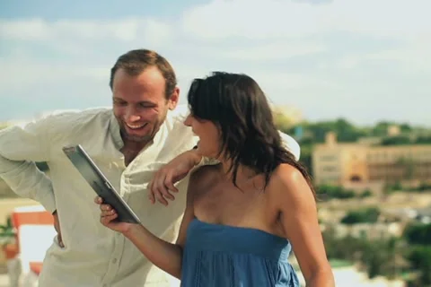 Happy couple chatting with tablet computer on the terrace Stock-Footage 17705386