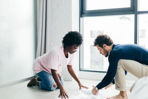 Happy couple checking bills while using digital tablet in kitchen 스톡 사진