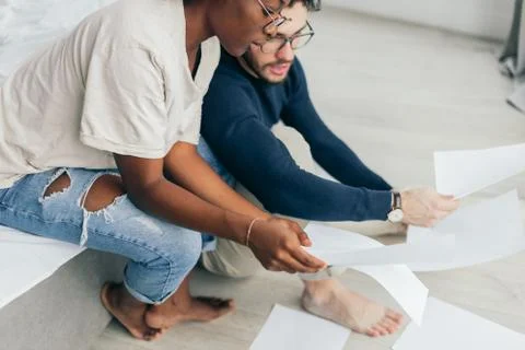 Happy couple checking bills while using digital tablet in kitchen Stock Photos