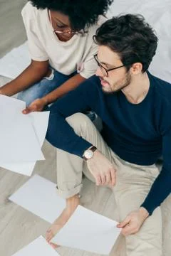 Happy couple checking bills while using digital tablet in kitchen Stock Photos
