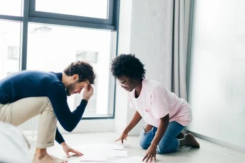 Happy couple checking bills while using digital tablet in kitchen Foto stock