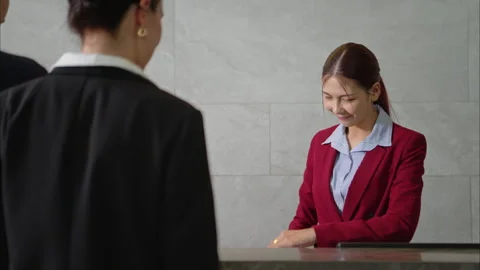 Happy couple checking in at hotel reception Stock Footage 316366994