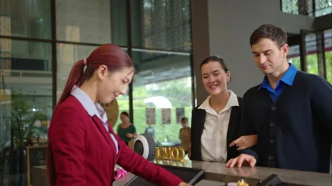 Happy couple checking in at hotel reception Stock Footage 316367011