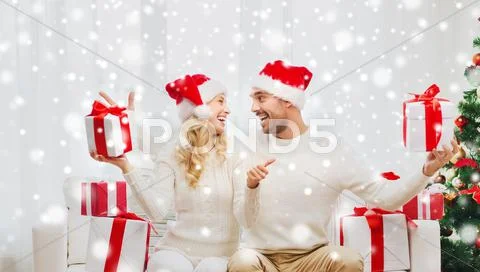 Happy couple with christmas gifts and thumbs up Stock Photos
